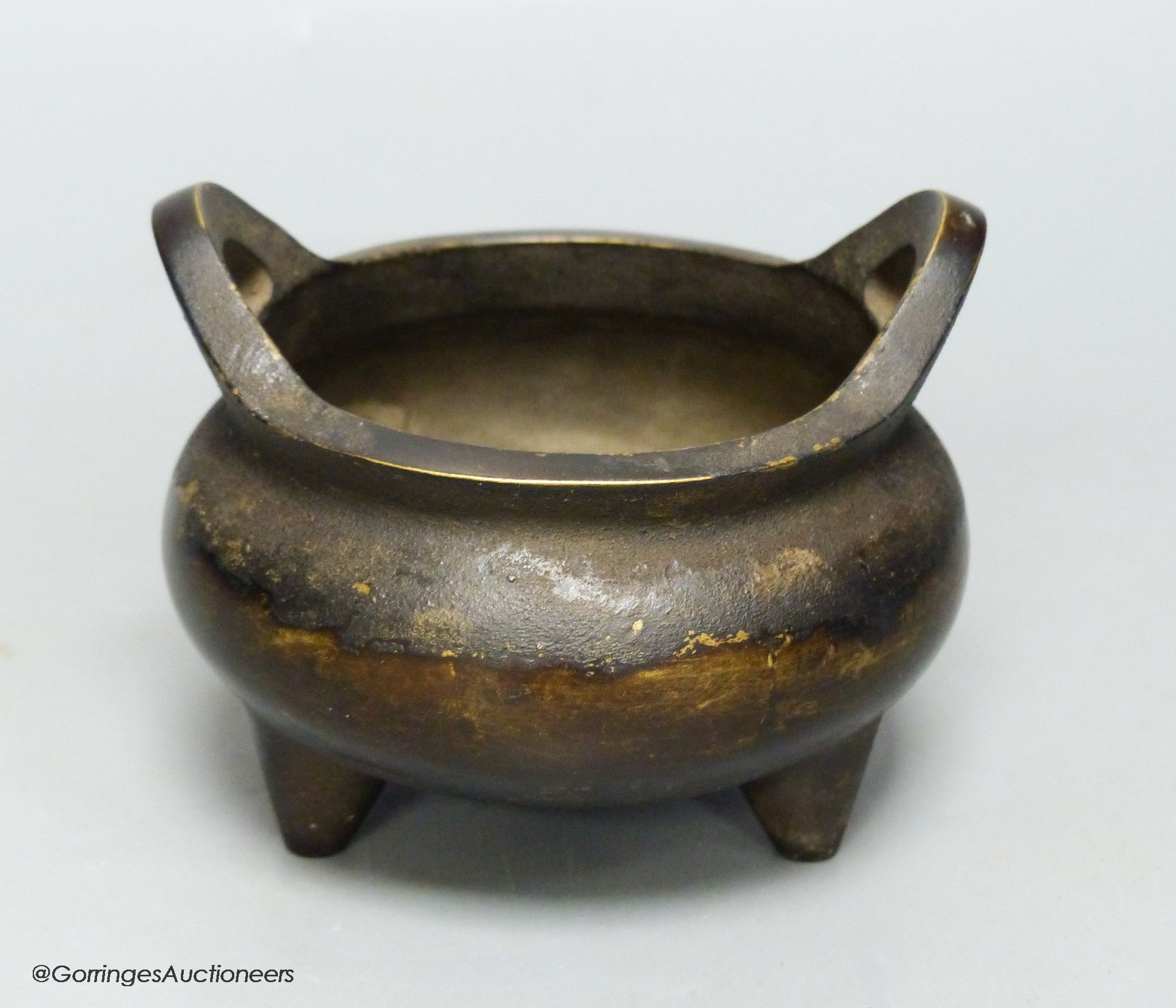 A Chinese bronze tripod censer, Xuande four character mark height 10cm